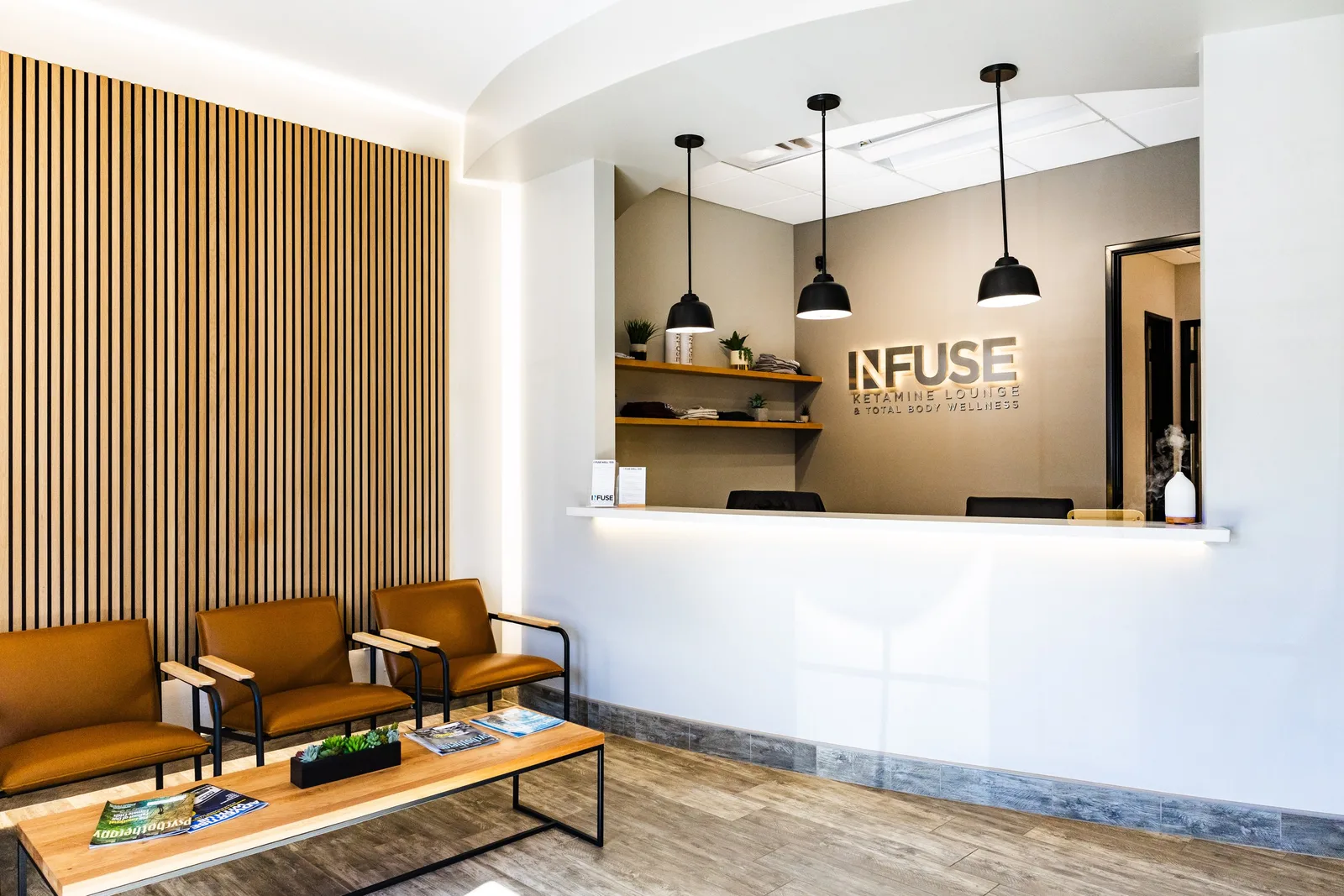 Empty signed Infuse reception counter and lounge entrance.