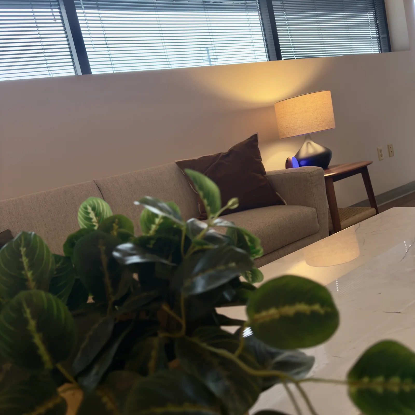 Empty Green Hills office waiting room with seating, table, and wall artwork.