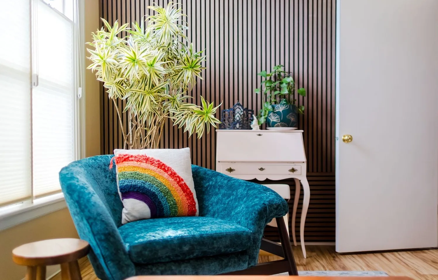 Empty ketamine treatment room with reclining chair, plants and privacy divider.