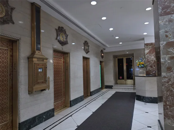 Interior corridor/elevator entrance shown with the clinic location information