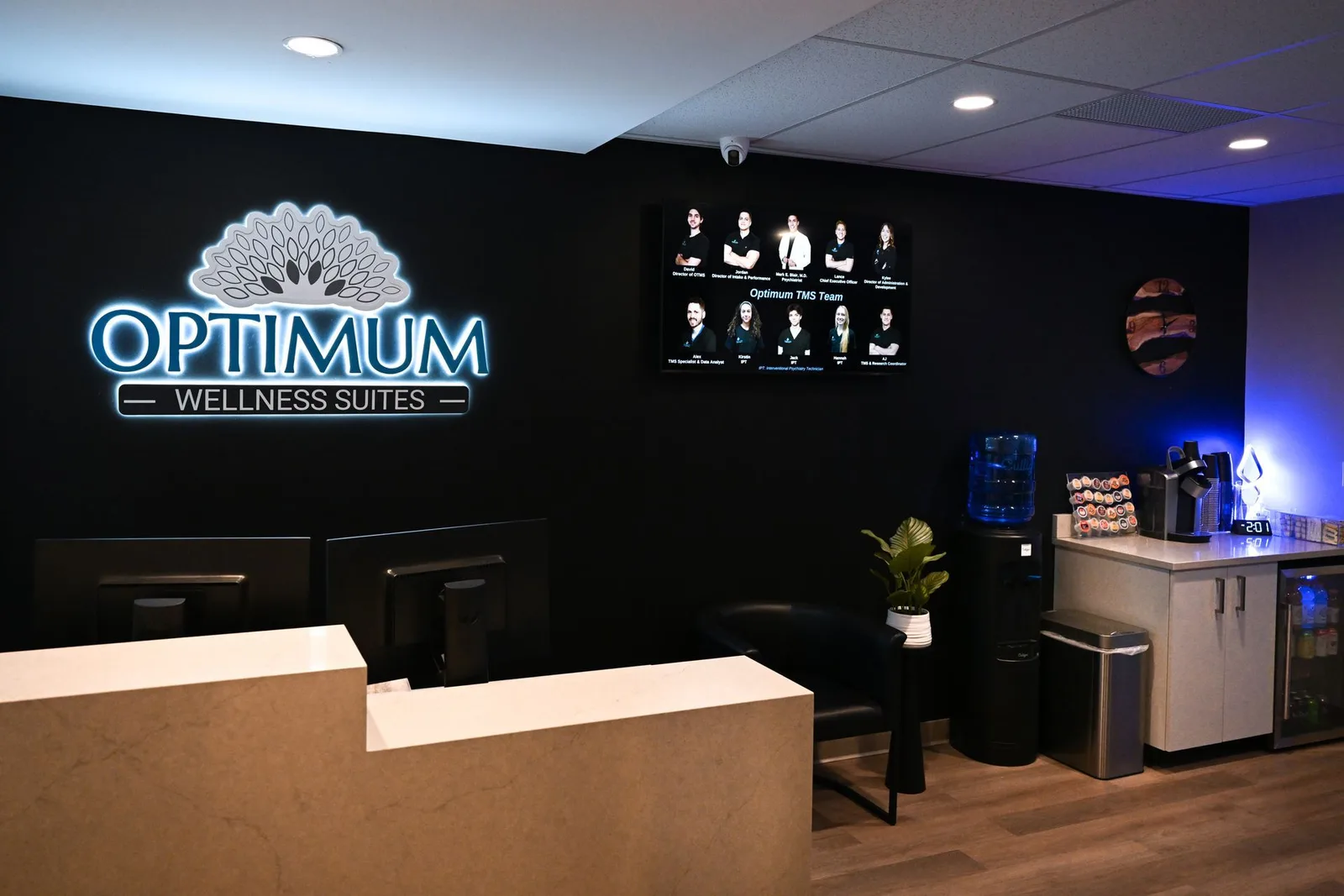 Signed Optimum TMS and Wellness reception area.