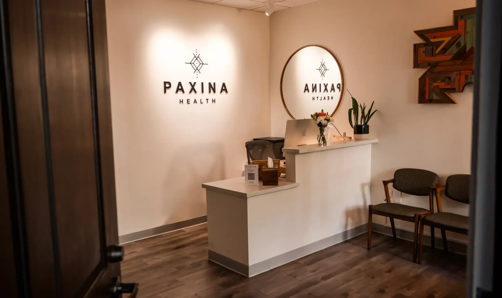 Signed Paxina clinic reception desk and waiting area.