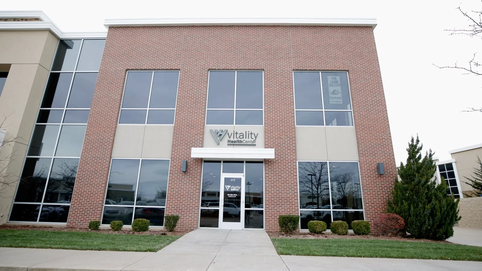 Signed Vitality Health Center office building and front entrance.