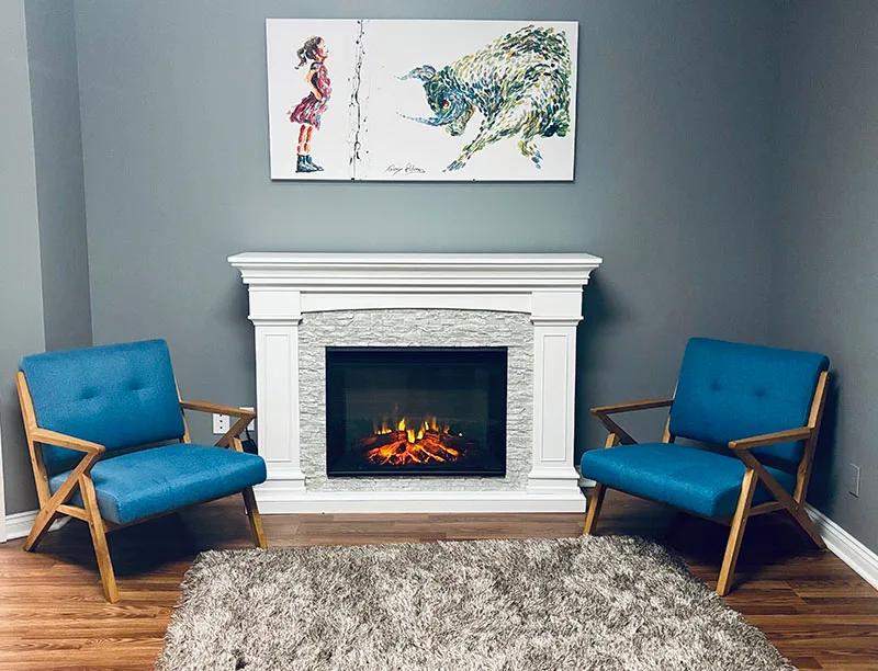 Empty Refuge Mental Health office with chairs and fireplace.