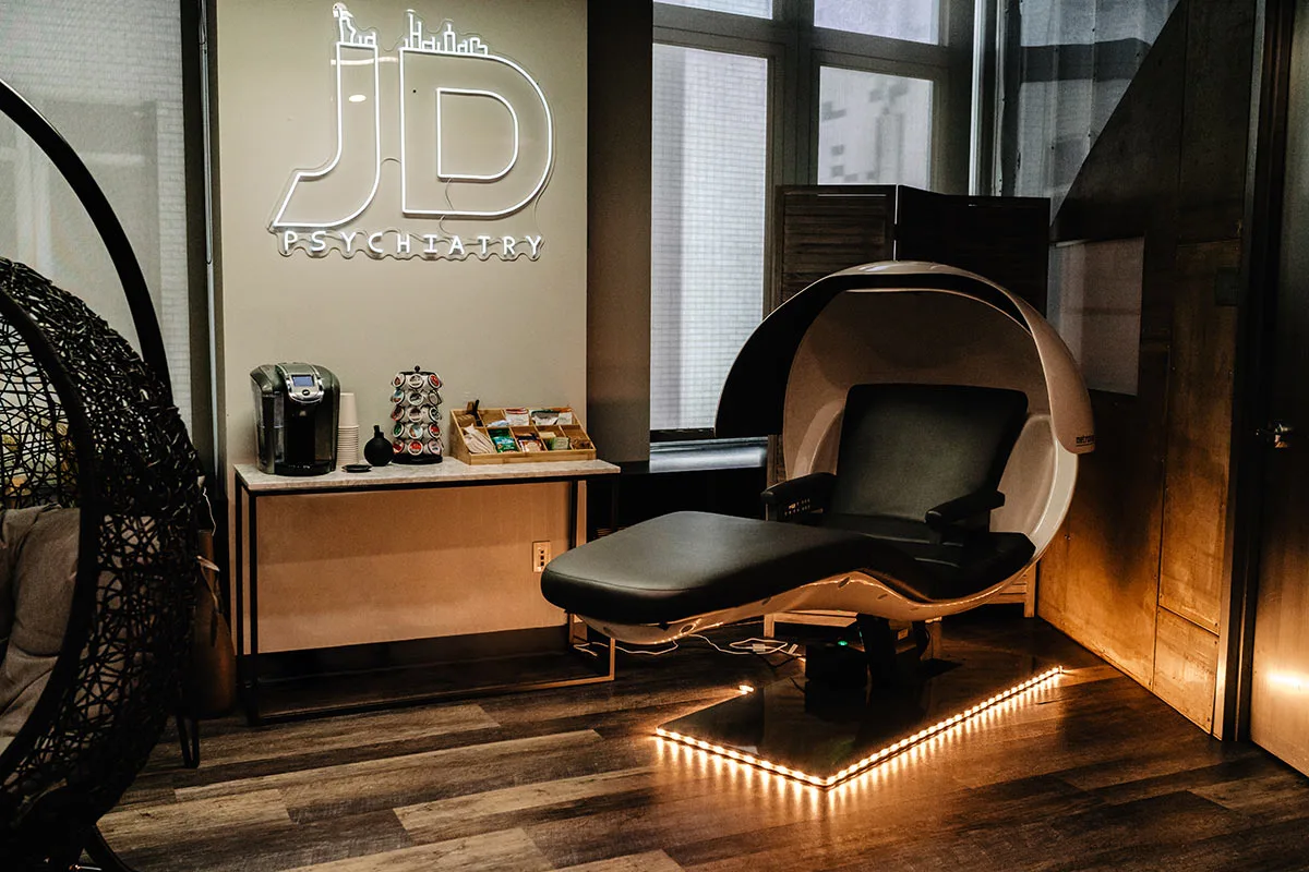 Treatment room with a reclining treatment pod and Dr. Ditzell wall branding