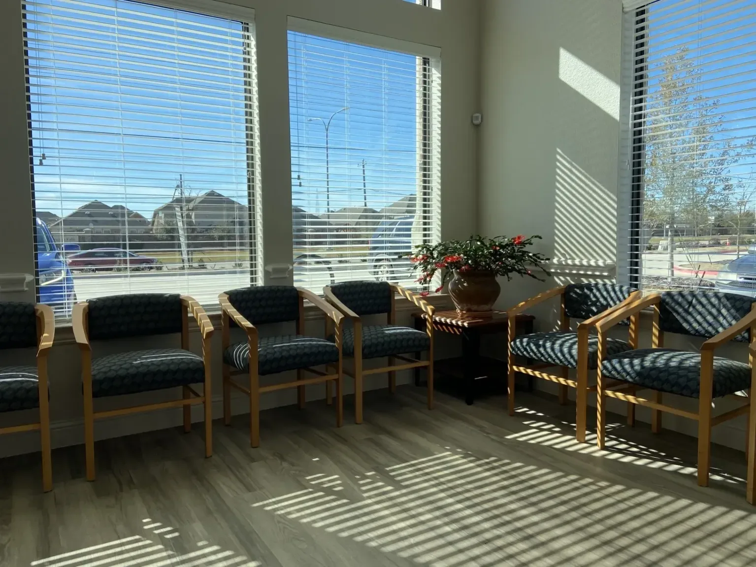 Empty Mercy Psychiatry waiting room with chairs and large windows.