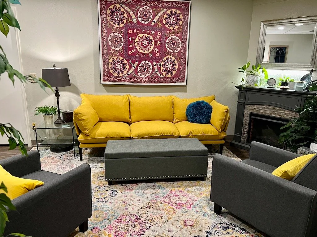 Empty Wily Wellness clinic lounge with yellow sofa.